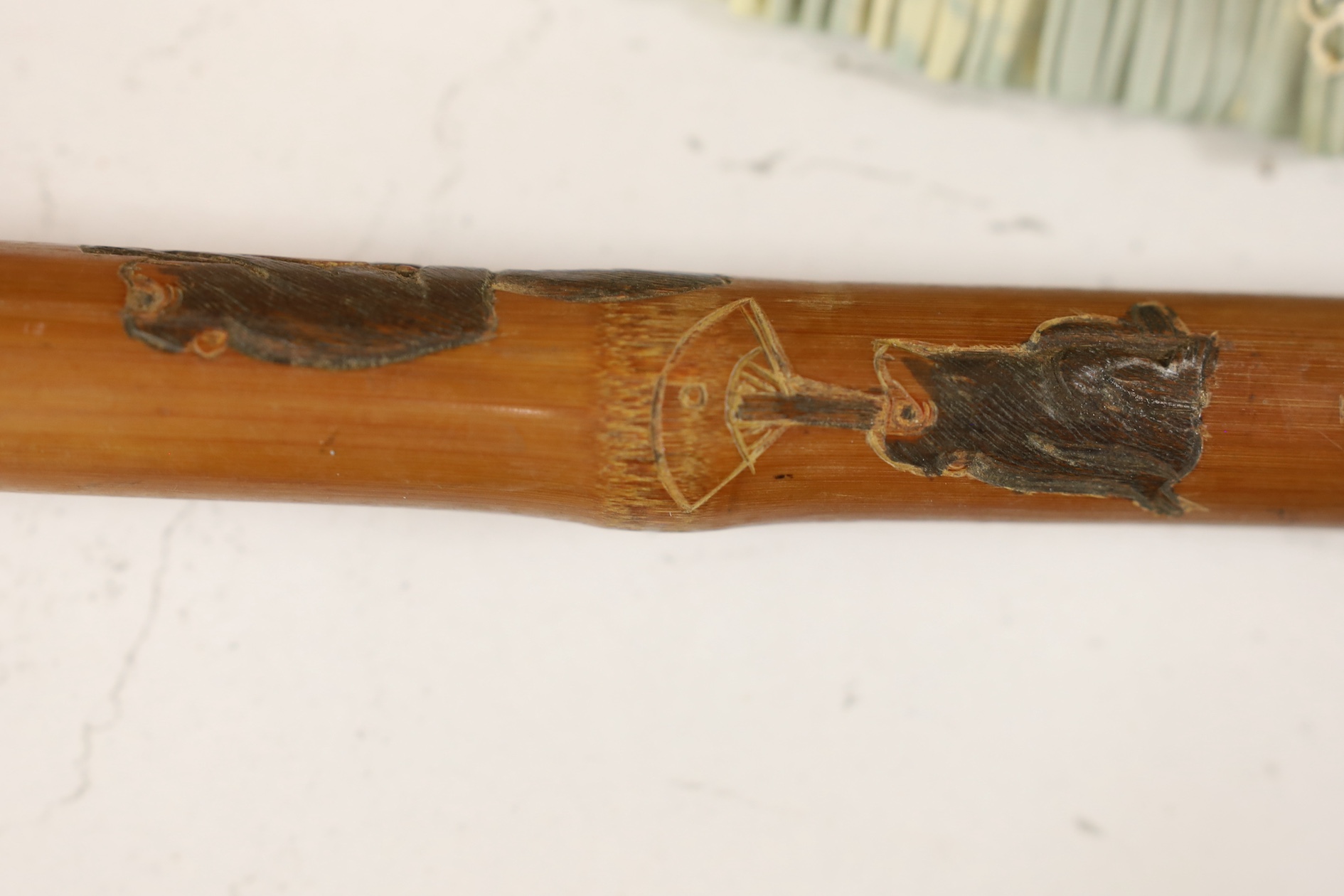 A Japanese carved and signed walking cane, 87cm high. Condition - fair to good